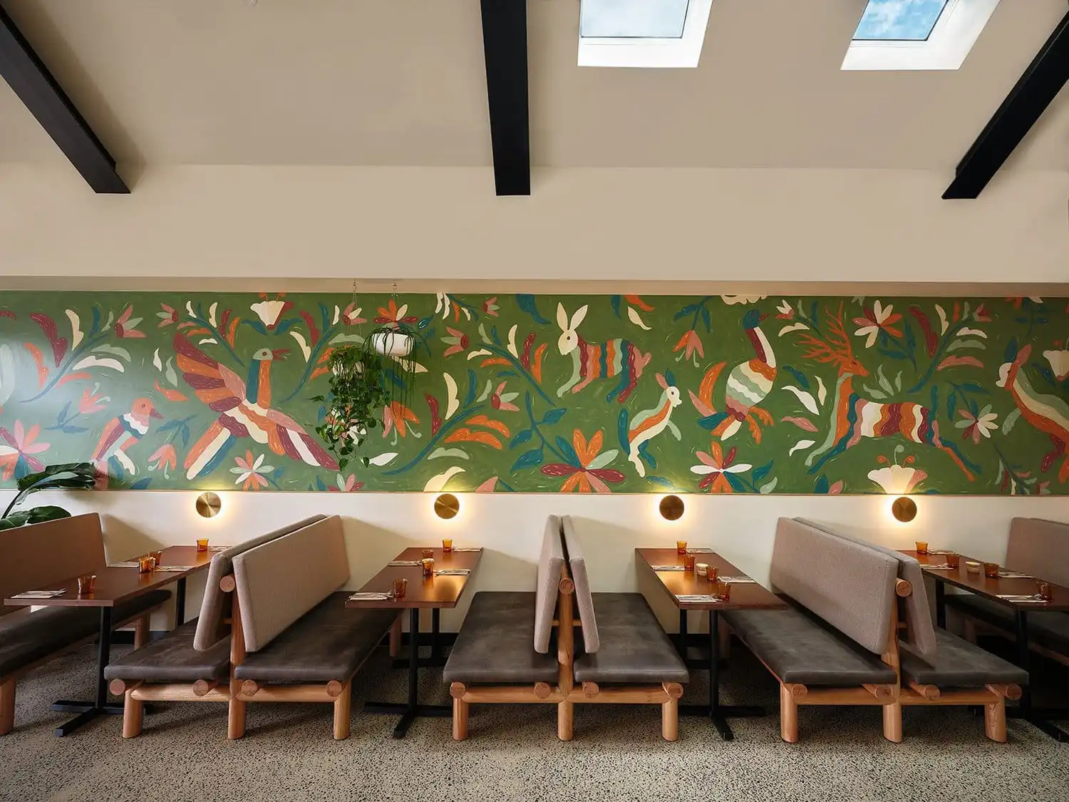 Banquette seating beneath the hand-painted mural
